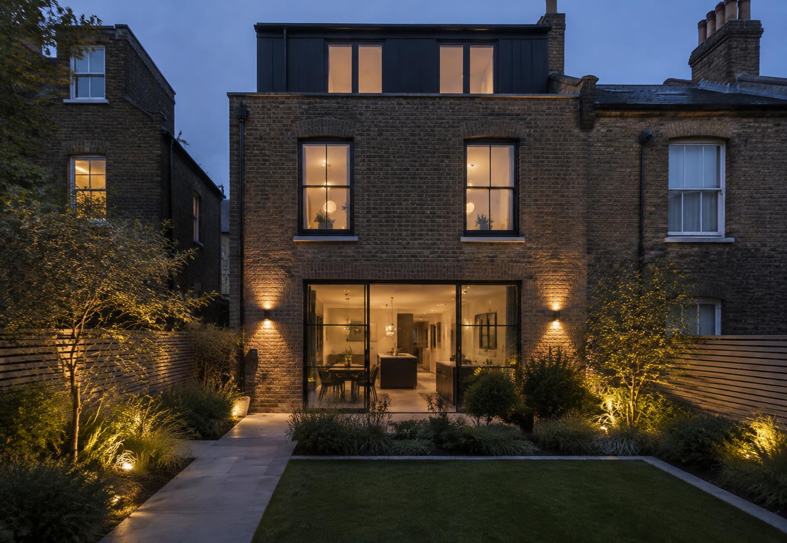 Warm exterior lighting illuminating a contemporary entrance